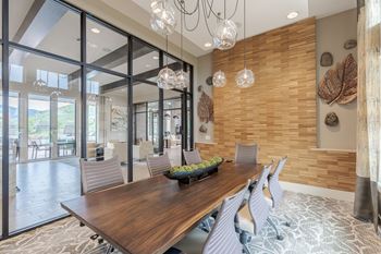 A modern dining room with a wooden table and chairs.